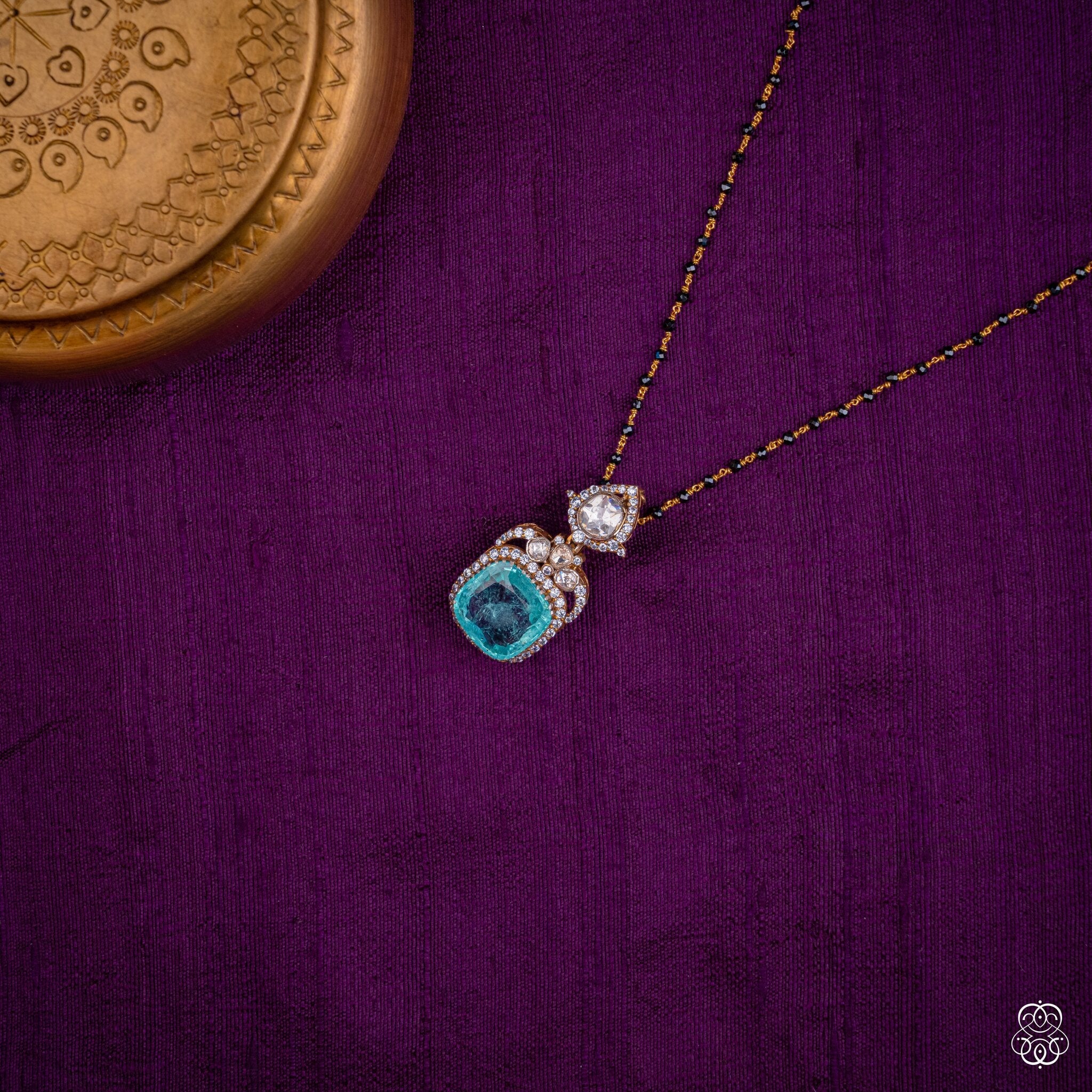 Ambujakshi aqua emerald pendant styled on a black bead chain
