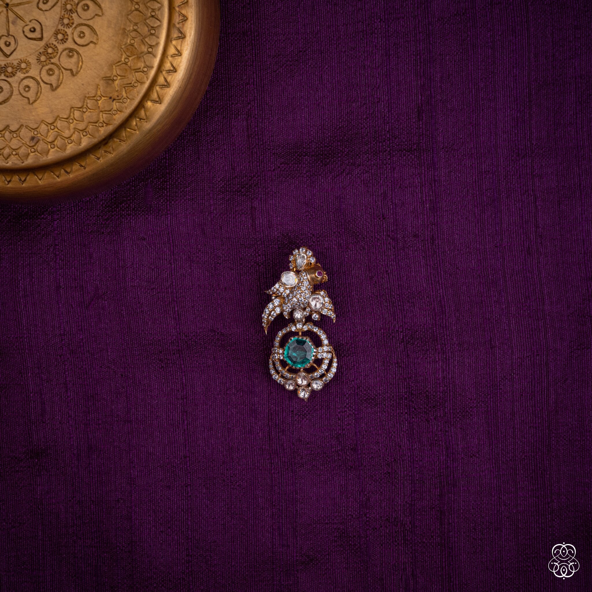 Chakravaki bird pendant with a round lab-grown emerald and moissanites in 92.5 sterling silver with 22k gold plating