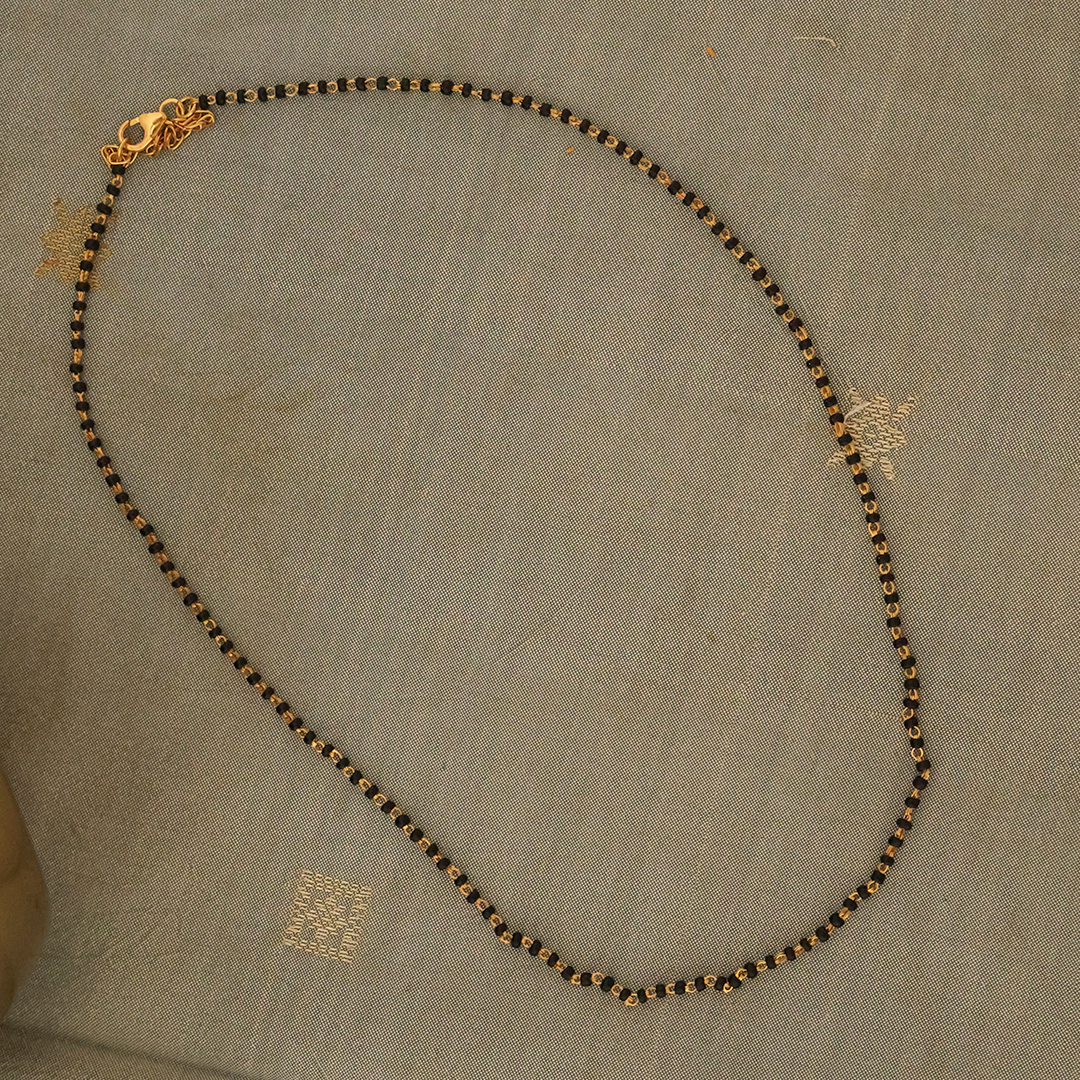 Electro gold plated 92.5 silver black bead chain displayed on a textured background