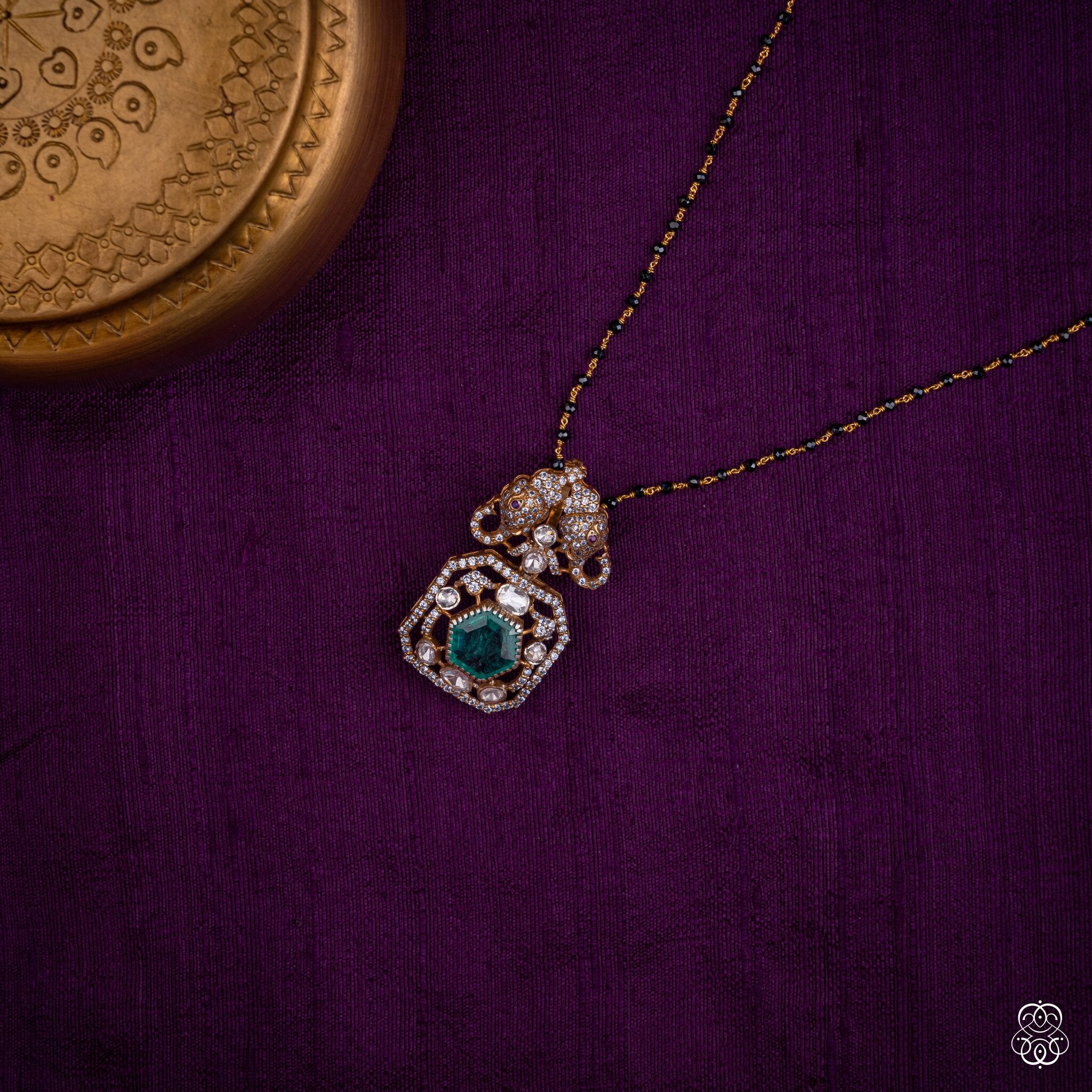 Gajayugma elephant emerald pendant styled on a black bead chain