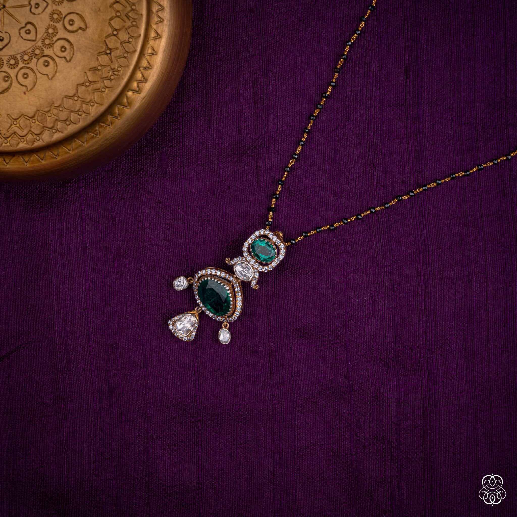 Haritanjali emerald drop pendant styled on a black bead chain