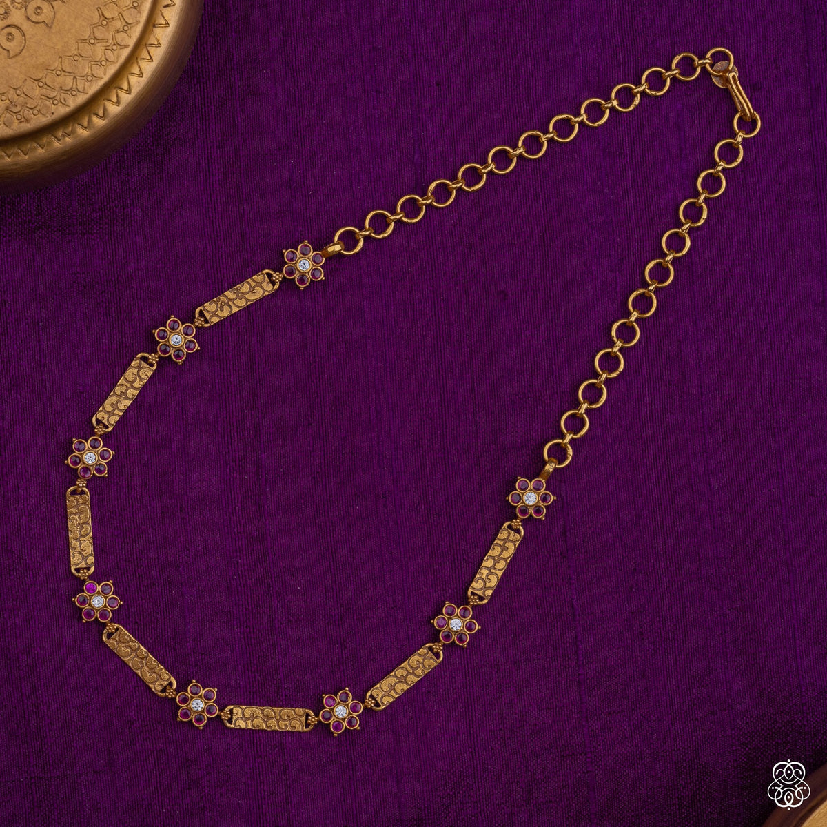 Close view of the ruby and kundan flowers on the Kusumavali bar necklace