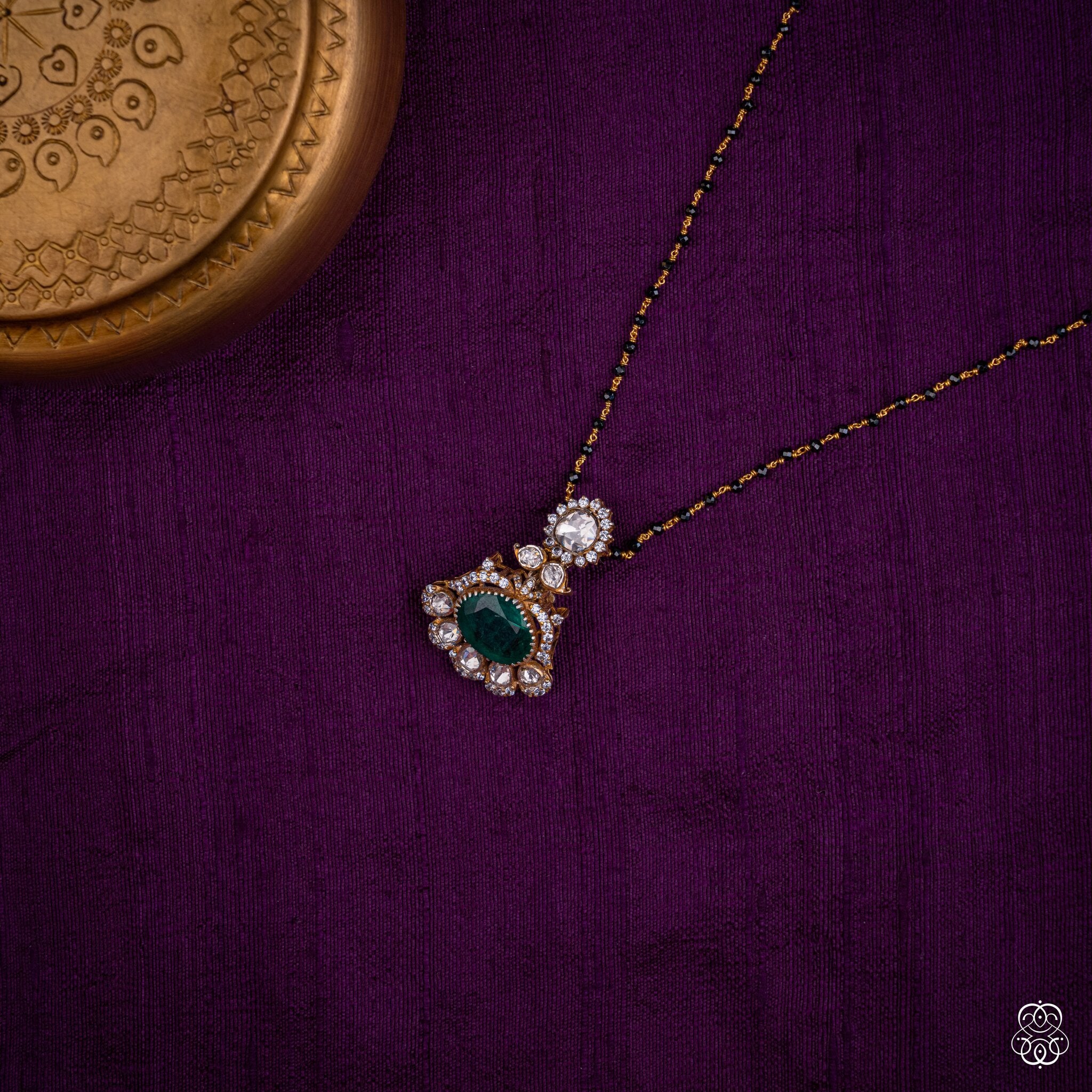 Marakatavalli emerald moissanite pendant styled on a black bead chain