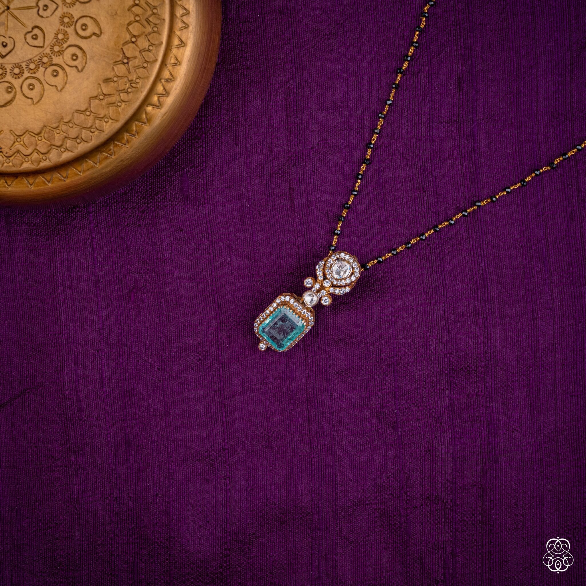 Nilarekha aqua emerald pendant styled on a black bead chain