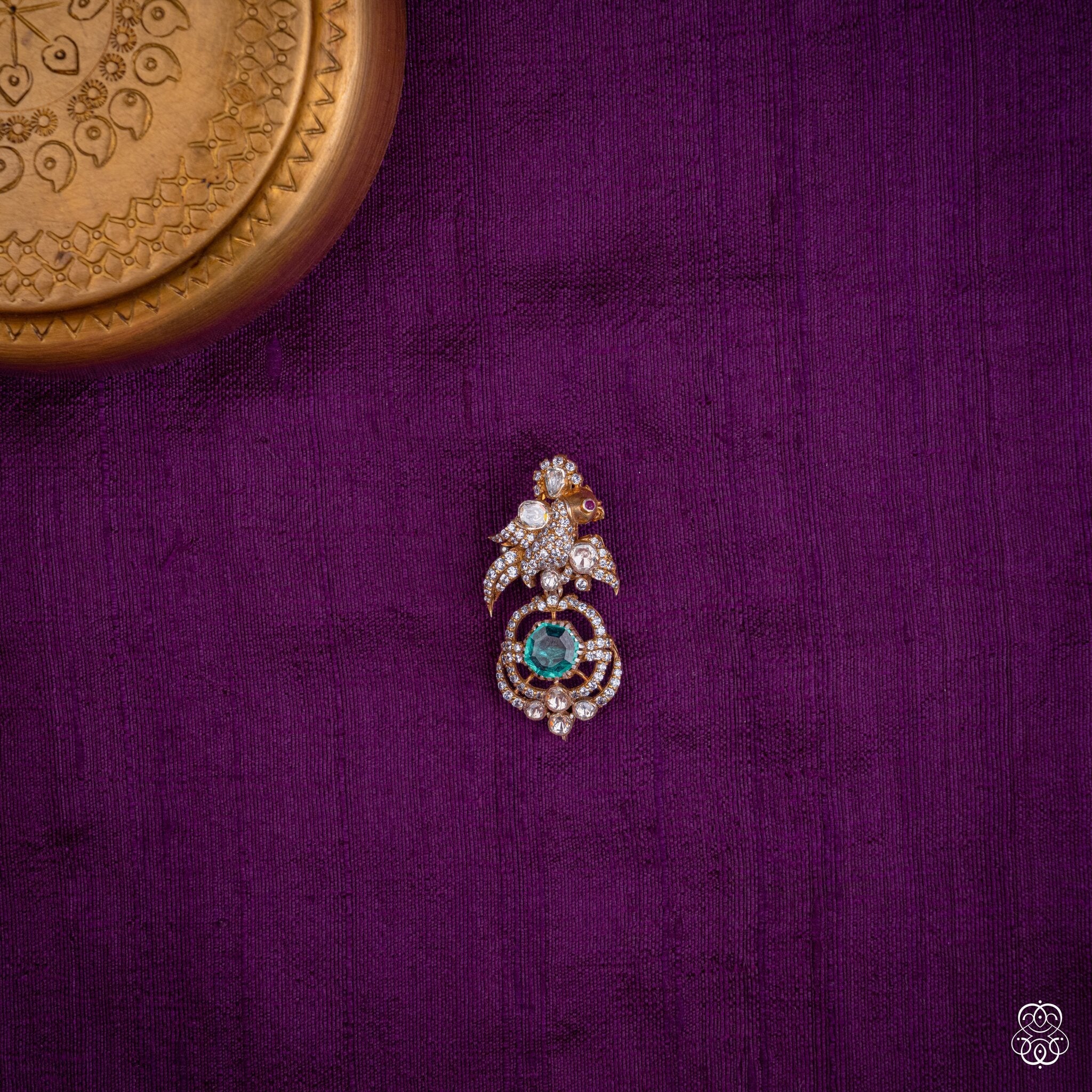 Chakravaki bird pendant with a round lab-grown emerald and moissanites in 92.5 sterling silver with 22k gold plating