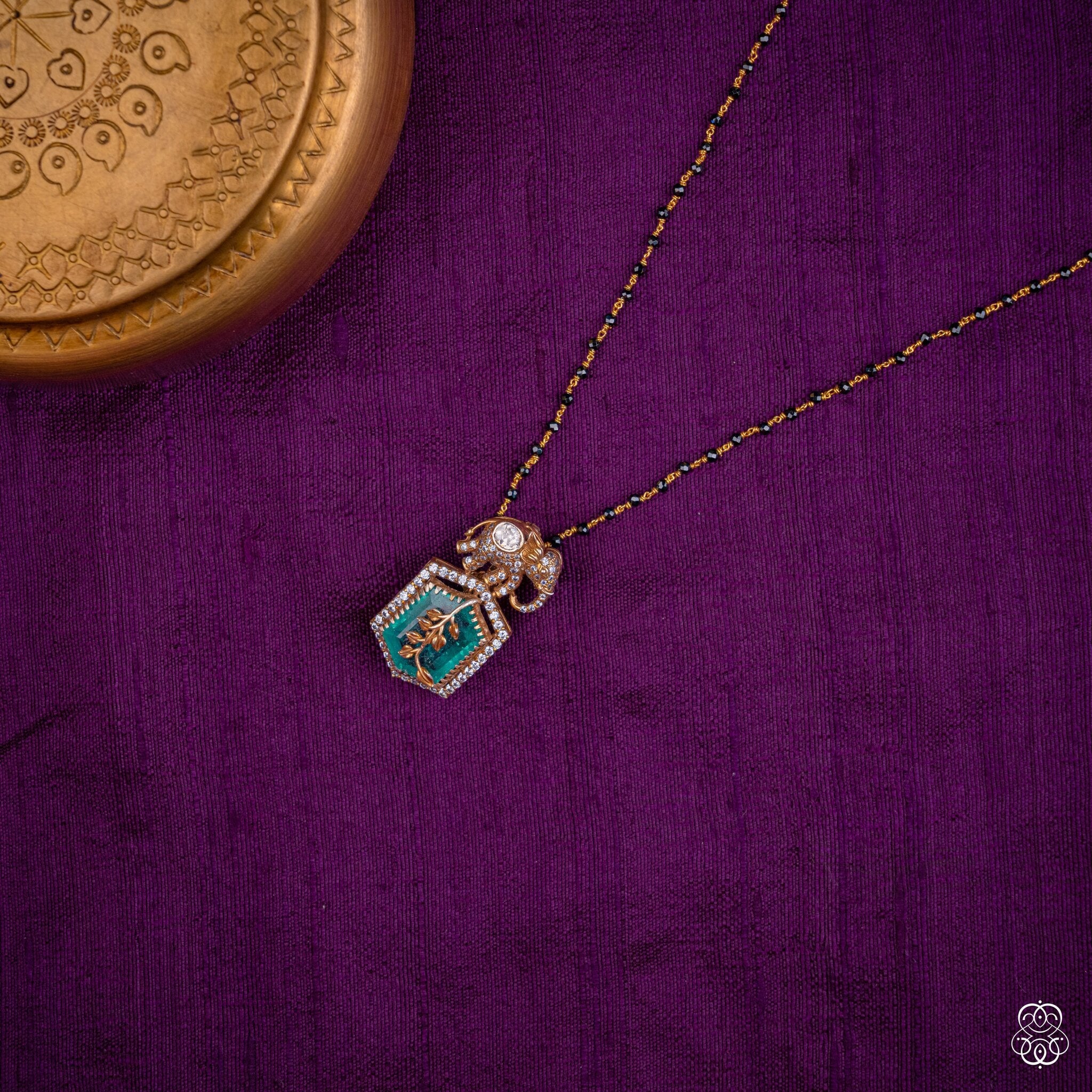 Gajaharita elephant emerald pendant styled on a black bead chain