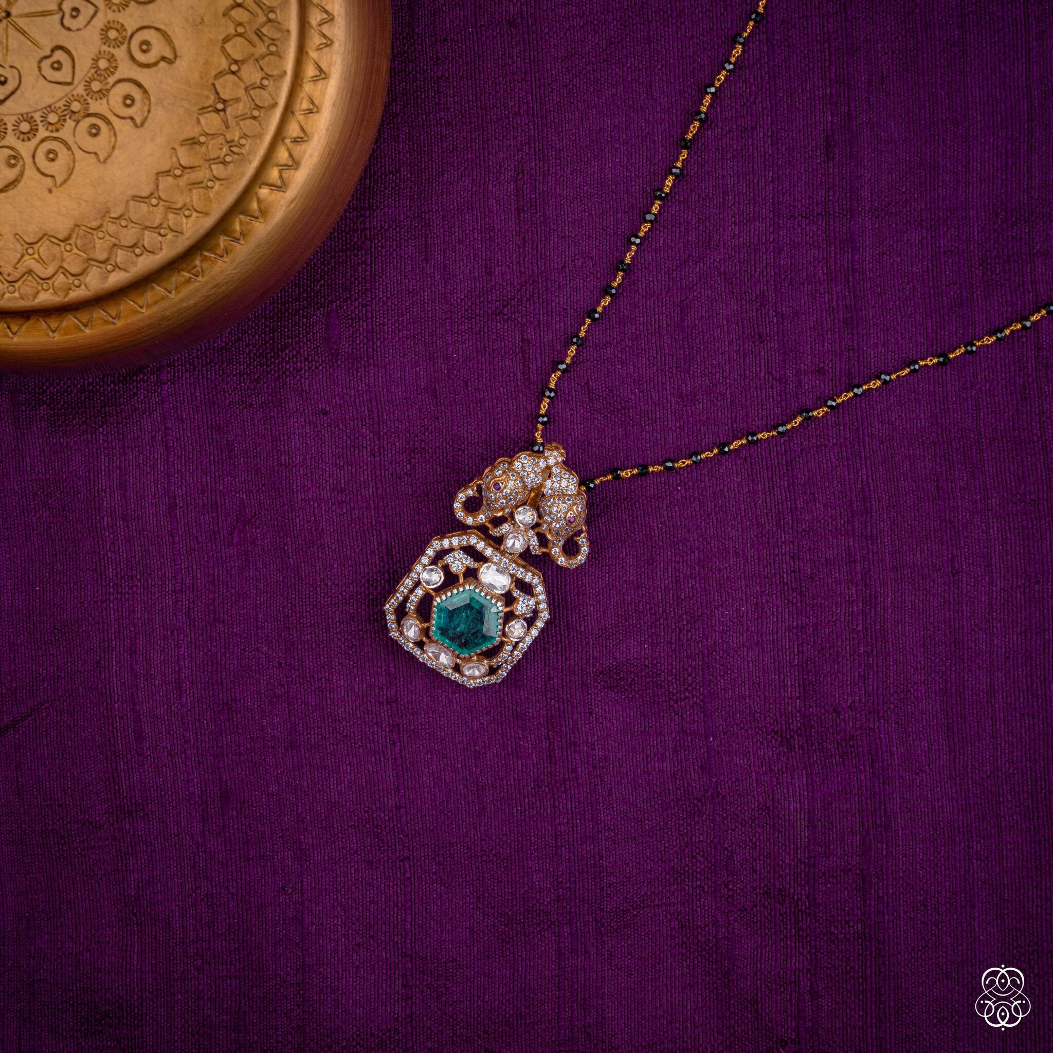 Gajayugma elephant emerald pendant styled on a black bead chain