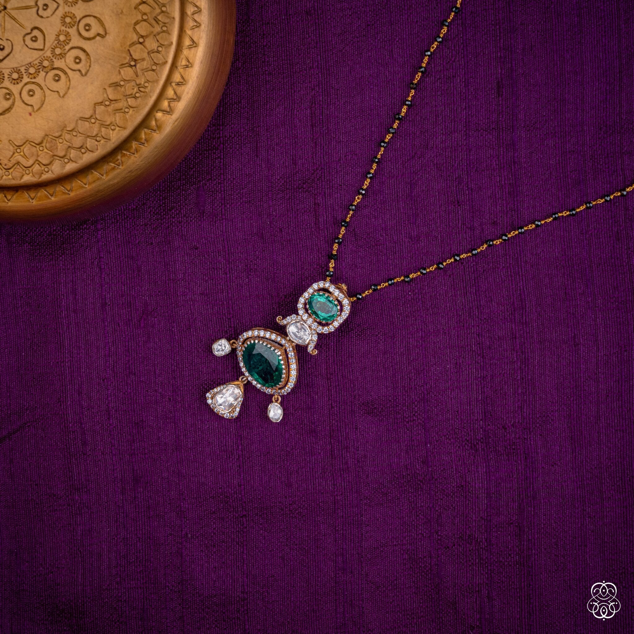 Haritanjali emerald drop pendant styled on a black bead chain