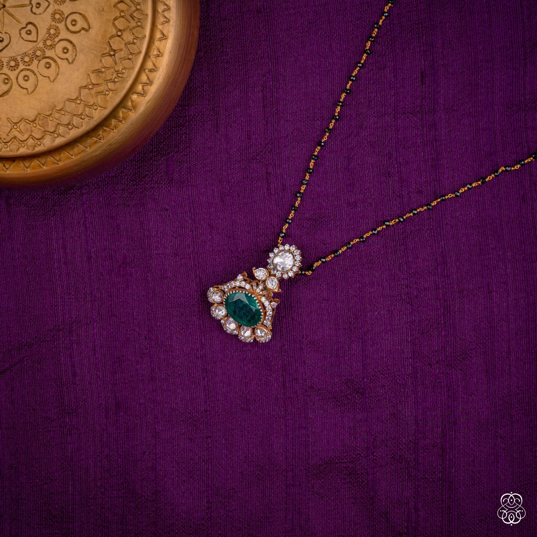 Marakatavalli emerald moissanite pendant styled on a black bead chain