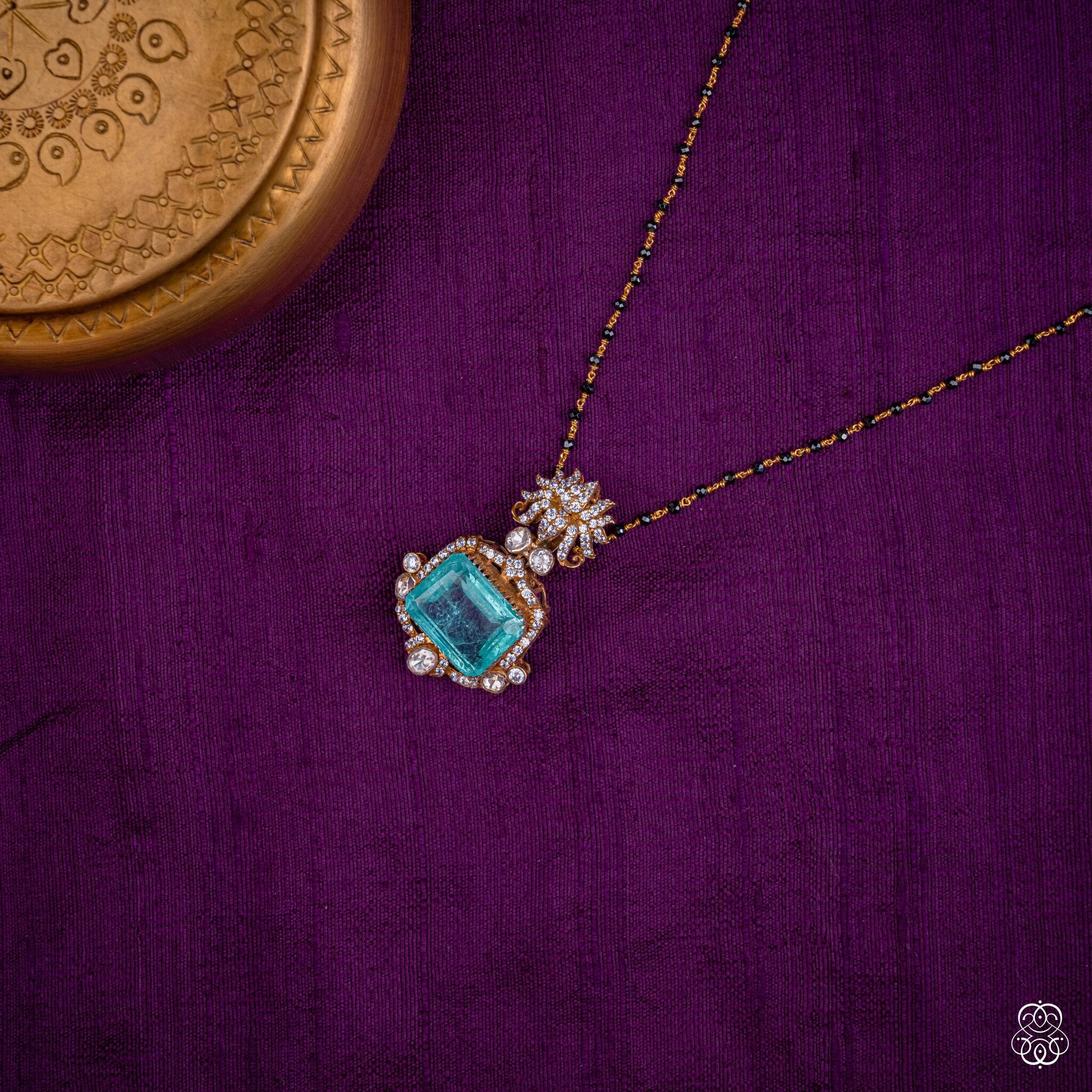 Vidyunmala aqua emerald pendant styled on a black bead chain